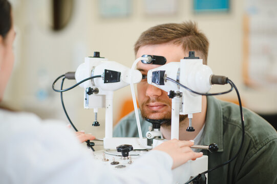 Ophthalmologist conducting strabismus diagnosis using synoptophore
