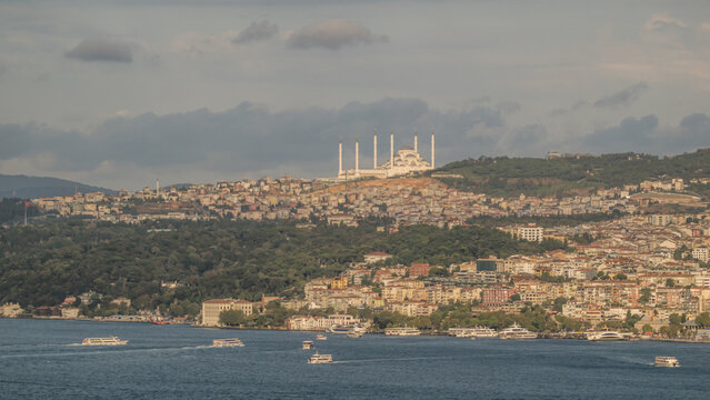 Bosphorus strait with boats navigating Istanbul and Camlica Mosque