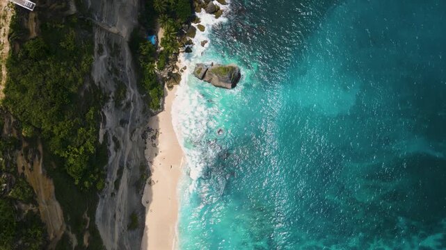 Aerial view of Diamond Beach with white sand and iconic limestone rock formations in Nusa Penida, Bali - 4K