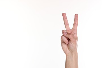 Fototapeta premium Man showing number two with fingers on white background, closeup. Space for text