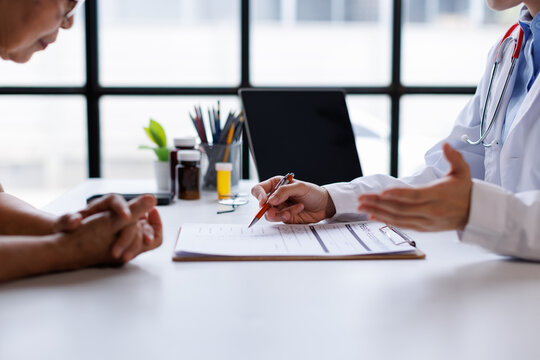 Doctor discussing treatment plan with senior patient, explaining medication and healthcare options during a medical consultation in clinic office