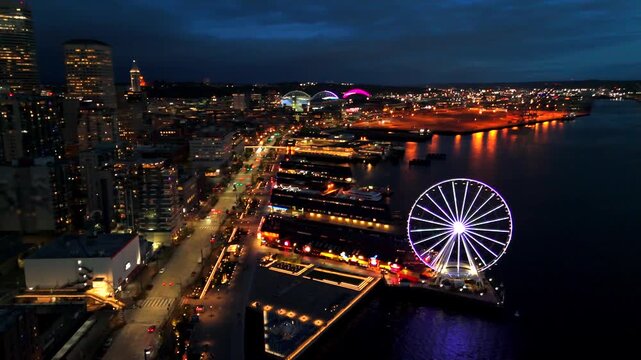 Drone view of Seattle waterfront with Great Wheel traffic lights and Elliott Bay