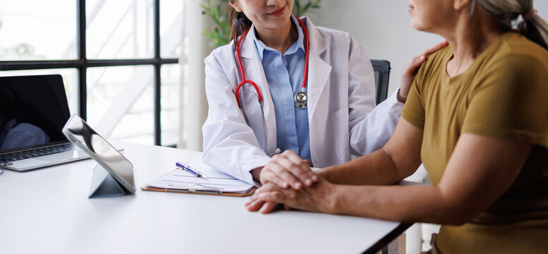Doctor showing empathy and providing emotional support to an older patient during a medical consultation in a clinic, offering reassurance and care
