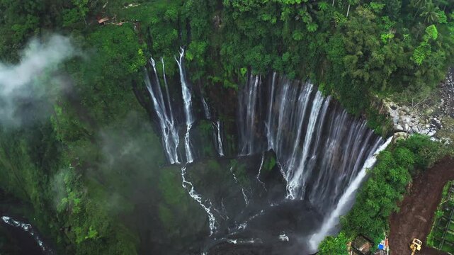 Drone flight footage of stunning Tumpak Sewu waterfall, East Java, Indonesia