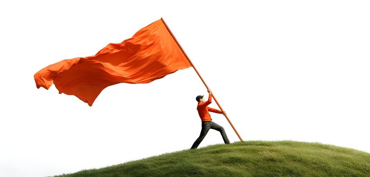 Man in orange shirt holding large orange flag on green grassy hill isolated on white background