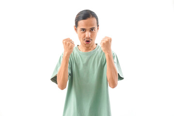 Naklejka premium young handsome Indonesian, Asian man in green shirt positive expression, joyful and exciting isolated on white background. Happy adorable glad man rejoices success
