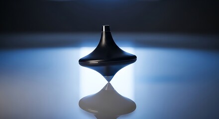 Fototapeta premium Black metal spinning top toy rotating on a smooth surface with soft blue lighting and reflection
