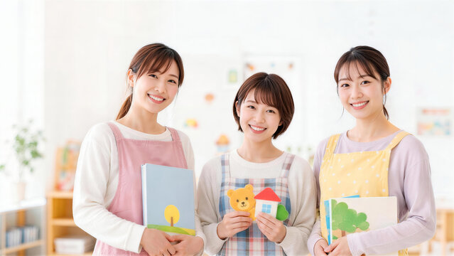 保育園で絵本や手作りおもちゃを持ち笑顔を見せる3人の保育士