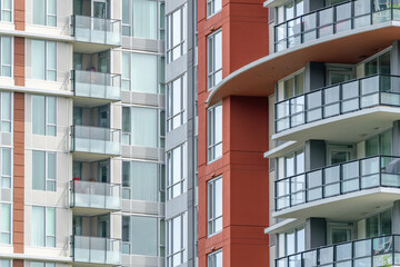 Obraz premium Modern apartment building facades with balconies and glass windows