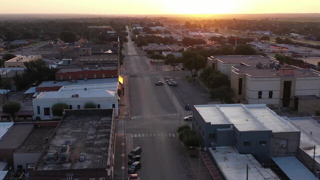 Aerial Drone View of Commercial Retail Buildings and Streets in Rural Town of Sweetwater, Texas At Sunset Dusk