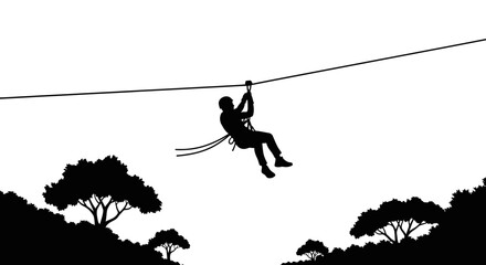 Zipliner hangs from a long cable while gliding across a vast forest valley in this black silhouette. © NGLARANGAN