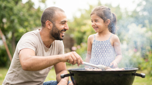 Father's Day Middle Eastern dad grilling with daughter laughing outdoors showing joy happiness fun bonding for family celebration lifestyle entertainment content promotional materials