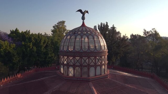 Aerial orbit of the ornamental stained-glass dome of the Kiosco Morisco in CDMX at dawn, Mexico