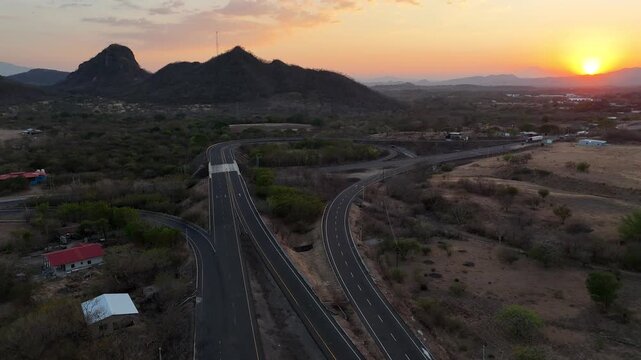 Drone view of Modern Honduran Highway Corridor at sunset, Investment and Logistics Connectivity