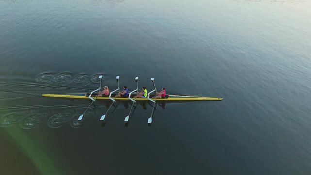 Aerial Four Female Athletes Rowing Halifax Canada Sunrise Calm Ocean Aerial Four Female Athletes Rowing In Sync Halifax Canada Sunrise Calm Ocean Water Smooth Movement Summer Training Scene 4K