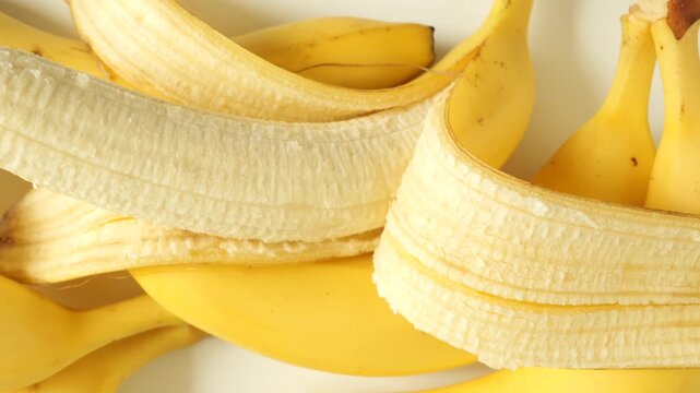 Ripe yellow bananas on a white background