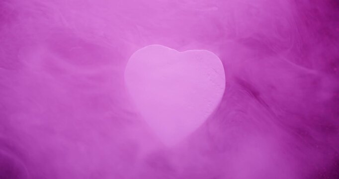 Pink heart. Fume steam. Defocused purple red color glitter rock texture smoke bright haze on abstract vibrant romantic bokeh background.