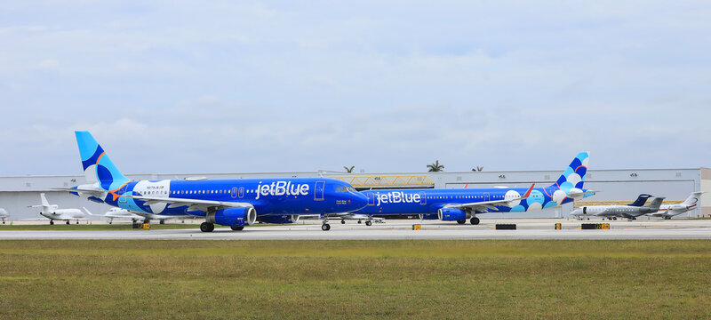  Jet Blue planes on the Fort Lauderdale Florida International Airport.  Jet Blue offers discounted $99 one-way rescue fares for stranded Spirit Airlines customers.