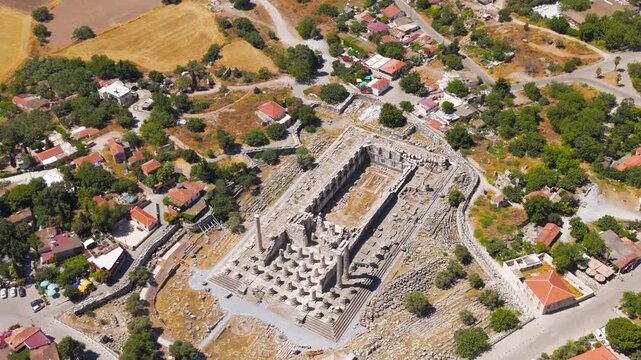 Didim, Turkey. The colossal Temple of Apollo at Didyma, its forest of towering Ionic columns and deep stepped podium revealed in a sweeping aerial drone view under bright summer sun. Aerial View, Dep