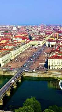 Vertical video. Turin, Italy. Aerial flight over the neoclassical Gran Madre di Dio church, its domed silhouette and grand staircase set against Piazza Vittorio Veneto and the distant Mole Antonellia