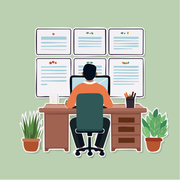 Man working at desk with computer and wall charts