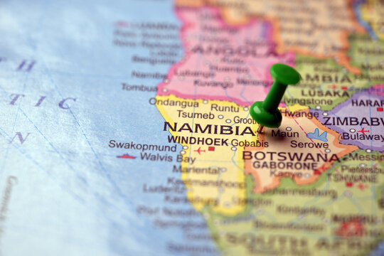 Green Push Pin Highlighting Namibia on Paper World Map Macro Close Up with Soft Blur