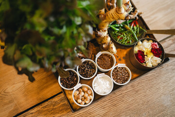 Spice bowl with fresh herb and flower display on wooden table © chokniti