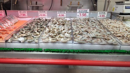 Fresh Raw Shrimps Assortment on Ice Display at New York City Fish Market © Jimrock