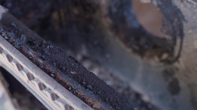 Cleaning fireplace from soot and creosote after heating season. Annual stove maintenance and chimney service end of winter