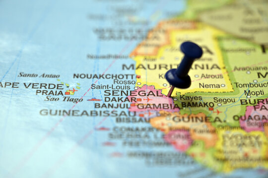 Blue Push Pin Highlighting Senegal on Vintage Paper World Map Macro Close Up