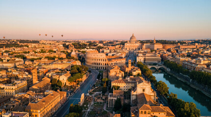 Obraz premium Panoramic aerial view of Rome at sunrise with hot air balloons over the city and the Colosseum.