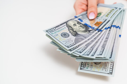 Woman carefully counting US dollar bills. Savings, accounting and household finance concept.