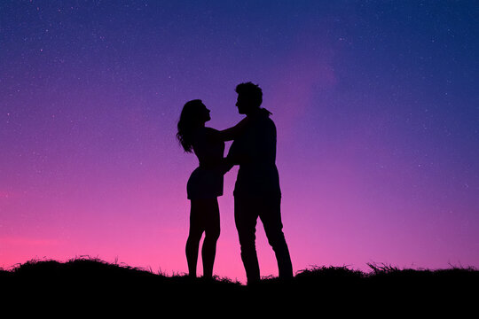 silhouette of two people dancing under the stars, their arms entwined in an embrace that radiates love and joy against a backdrop of a starry night sky