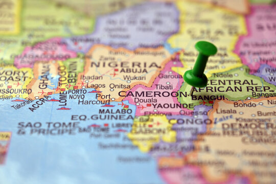 Green Push Pin Highlighting Cameroon on Paper World Map Macro Close Up with Soft Blur