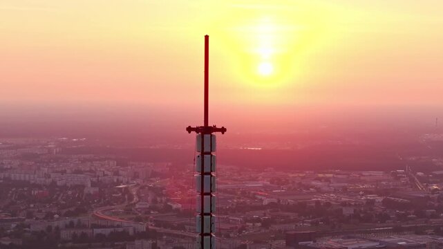 Drone rotation around Riga Radio and TV Tower during sunset in Latvia skyline