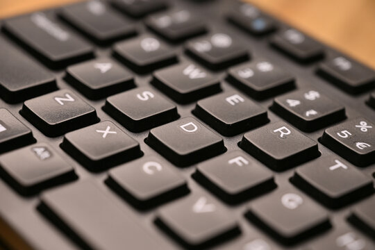 Side Angled Top View Macro Close-Up Black Computer Keyboard Highlighting D Key on Blurred Tech Background