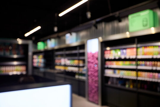 Blurred store aisle with colorful shelves and bright lighting background