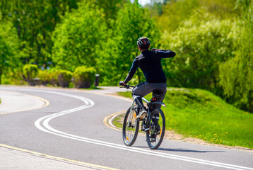 Fototapeta premium Cyclist ride on the bike path in the city Park 