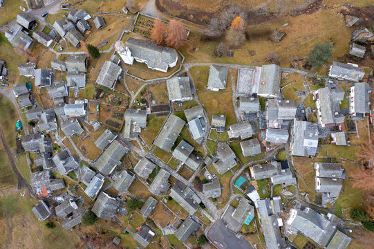 Aerial view of the traditional stone-roofed houses and the historic parish church in the alpine village of Bosco Gurin, Ticino, Switzerland.