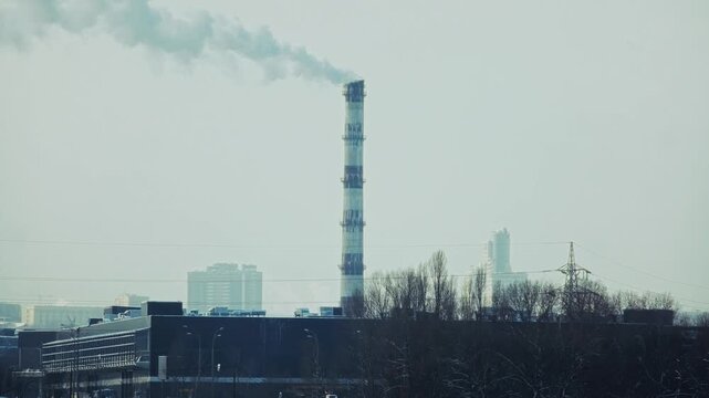 Industrial Chimney Releasing Thick Smoke into Atmosphere. Environmental Impact of Manufacturing and Energy Production