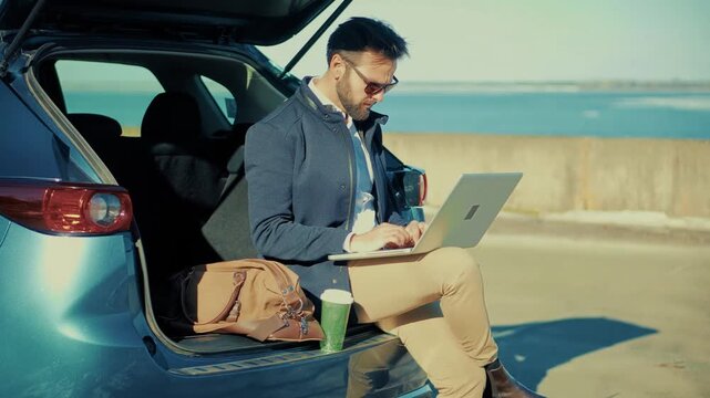 Specialist Using Notebook for Remote Work during Road Trip. Modern Tech Communication 
