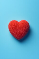 Obraz premium Textured red heart centered on blue background symbol