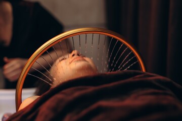 Fototapeta premium Woman receiving hydrotherapy spa facial treatment. Japanese spa head