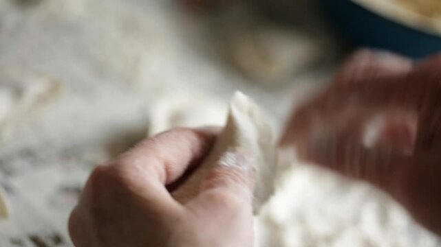 A chef preparing potato dumplings by hand