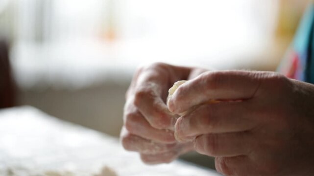 A woman makes potato dumplings at home, delicious homemade food made with her own hands