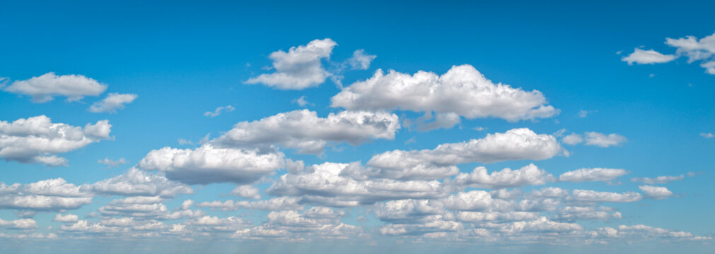 Clouds move in the blue sky. Tropical clouds at day time, white and blue. Transparent clouds layers. A clear blue sky adorned with fluffy white clouds. Calm serene cloud background.