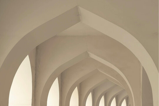 ​Minimalist utopian arches architecture background. Elegant white vaulted ceiling and repetitive arched corridor in a clean, modern aesthetic. High-end interior design with soft natural lighting on 66