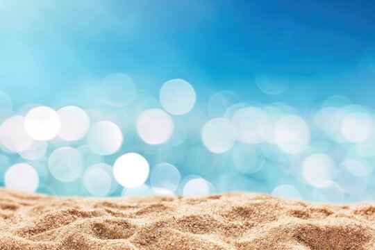 Close-up of sandy beach with a sparkling blue sea background under bright daylight.