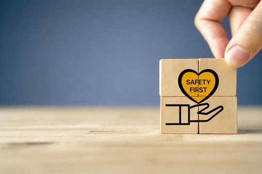Safety first symbols, work safety, caution work hazards, danger surveillance, zero accident concept. Wooden cubes with smart grey background. Employees safety awareness at workplace. Safety banner.