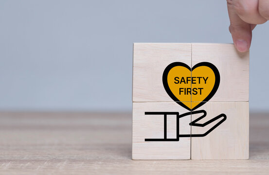 Safety first symbols, work safety, caution work hazards, danger surveillance, zero accident concept. Wooden cubes with smart grey background. Employees safety awareness at workplace. Safety banner.